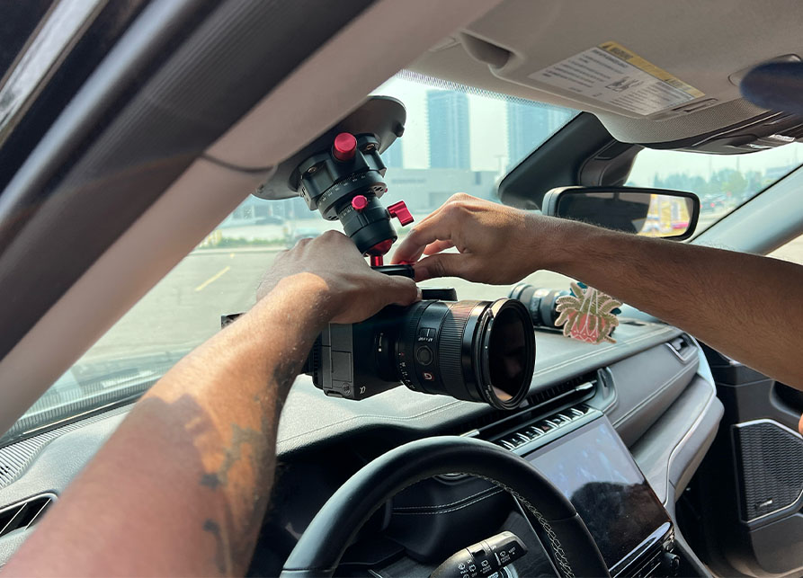 behind the scenes photo of photographer setting the camera in car